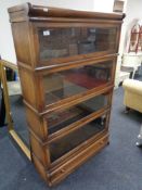 An Edwardian four tier oak stacking bookcase