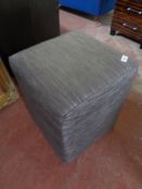 A cloth striped cube stool