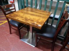 A cafe table together with a pair of wooden chairs (3)