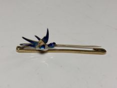A 15ct gold bar brooch with pearl and enamelled decoration modelled as a bird in flight