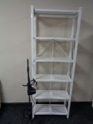 A contemporary metal folding bookshelf and a floor lamp