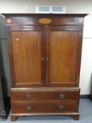 A Regency inlaid mahogany double door linen press converted to a wardrobe,