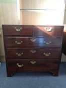 A George III mahogany five drawer chest with brass drop handles on bracket feet