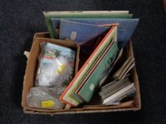 A box of postcards and postcards in books