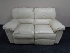 A cream leather two seater reclining settee
