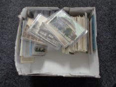 A box of twentieth century black and white & colour postcards