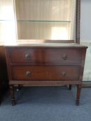 An Edwardian oak two drawer chest