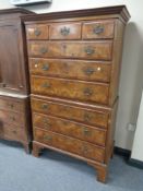 A George II walnut nine drawer chest on chest with brass drop handles on bracket feet