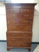 A George III inlaid mahogany chest on chest with brass drop handles raised on bracket feet
