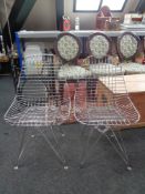 A pair of mid century metal dining chairs on hair pin legs