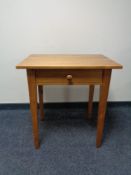 A pine side table fitted a drawer