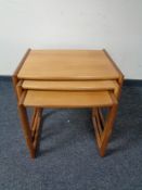 A nest of three teak tables