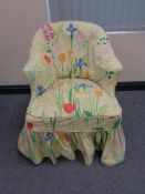 A 19th century lady's chair on oak legs with floral loose cover