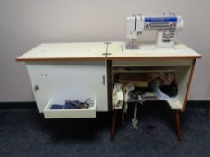 A New Home electric sewing machine in cabinet with accessories