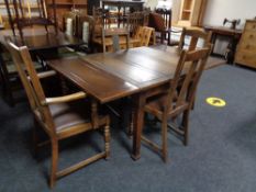 An oak pull out dining table and four chairs