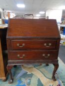 A mahogany bureau on claw and ball feet