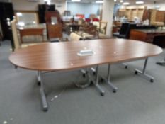 A contemporary four section boardroom table on wheels fitted with power points,