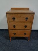 An Edwardian oak three drawer chest