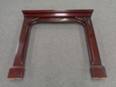 A contemporary mahogany effect fire surround
