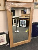 An oak effect flat framed mirror