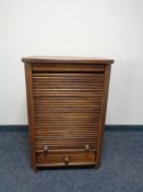An oak shutter front cabinet fitted internal shelf