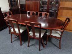 A nine piece Meredew dining room suite comprising cocktail cabinet, oval table with leaf,