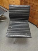 A Vitra Charles Eames designed Alu swivel chair upholstered in black leather with chrome frame