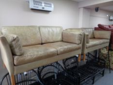 A pair of mid century Danish tan leather two seater settees