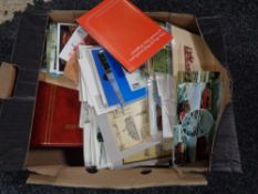 A box of assorted colour and monochrome postcards