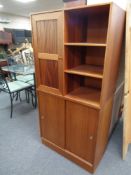A teak storage unit with sliding doors beneath