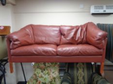 A contemporary Danish red leather two seater settee