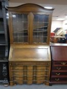 An oak leaded glass fall fronted bureau bookcase