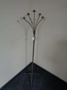 A wrought metal five way floor standing candle holder