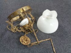 A Continental gilt metal hanging oil lamp with opaque glass resevoir (converted),