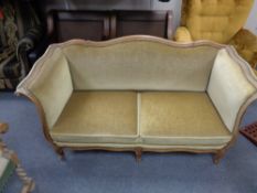 An early twentieth century continental beech two seater salon settee