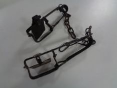 Two vintage gin traps