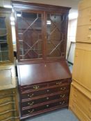 A reproduction mahogany bureau bookcase
