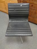 A Vitra Charles Eames designed Alu swivel chair upholstered in black leather with chrome frame