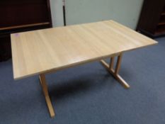 A contemporary extending table with two leaves