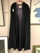 An Aquascutum of London black hooded cape, from the Millenium 2000 limited edition range.