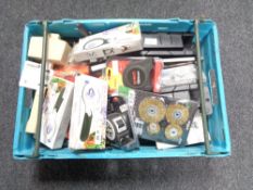A crate of tools, drill bits, tape measures,