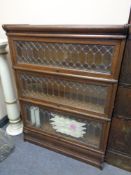 An early twentieth century stacking leaded glass oak bookcase