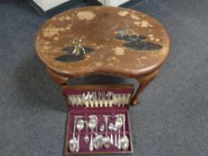 An oak canteen of Sheffield plated cutlery and a 20th century occasional table on claw and ball