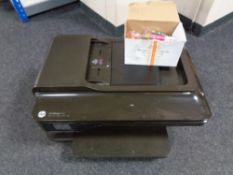 An HP office jet 7612 multi function printer and a box of ink cartridges