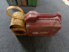 A metal railway lamp together with a jerry can