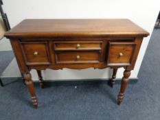 A contemporary side table fitted four drawers