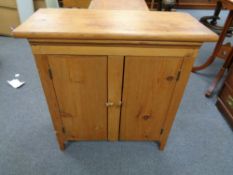 A pine two door low cupboard