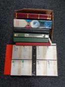 A box of seven folders of commemorative stamps,