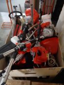 A crate of petrol garden multi tool engines and parts