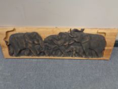 A carved panel depicting elephants